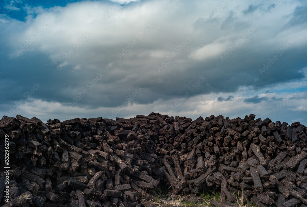 pile of peat bog cultivated for fuel drying in rural Ireland pile of peat bog cultivated for fuel drying in rural Ireland