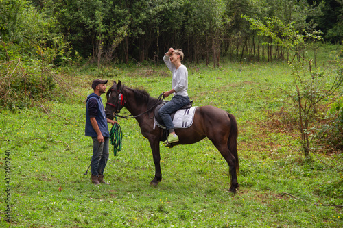 man and woman go horse riding © kavardakova