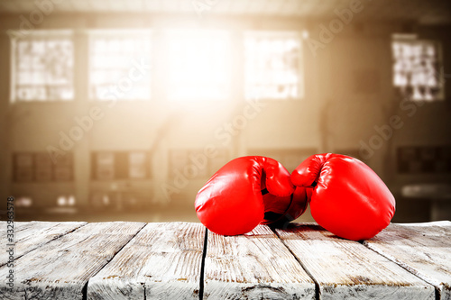 Картината върху платно Red boxing gloves on desk and free space for your decoration.