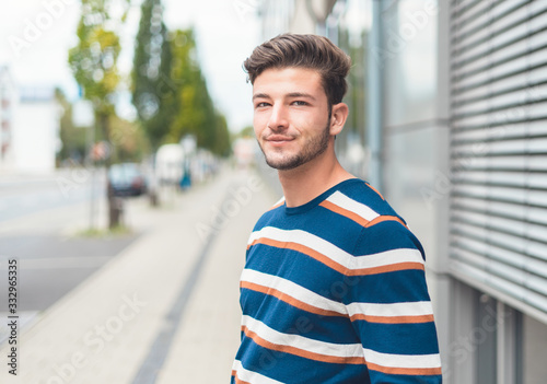 Portrait of young casual friendly man, selective focus