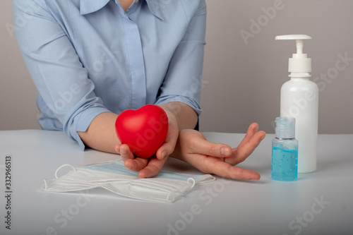 Woman using medical protective mask and antibacterial antiseptic gel for hands disinfection and health protection ,corona virus epidemic and infectious diseases photo