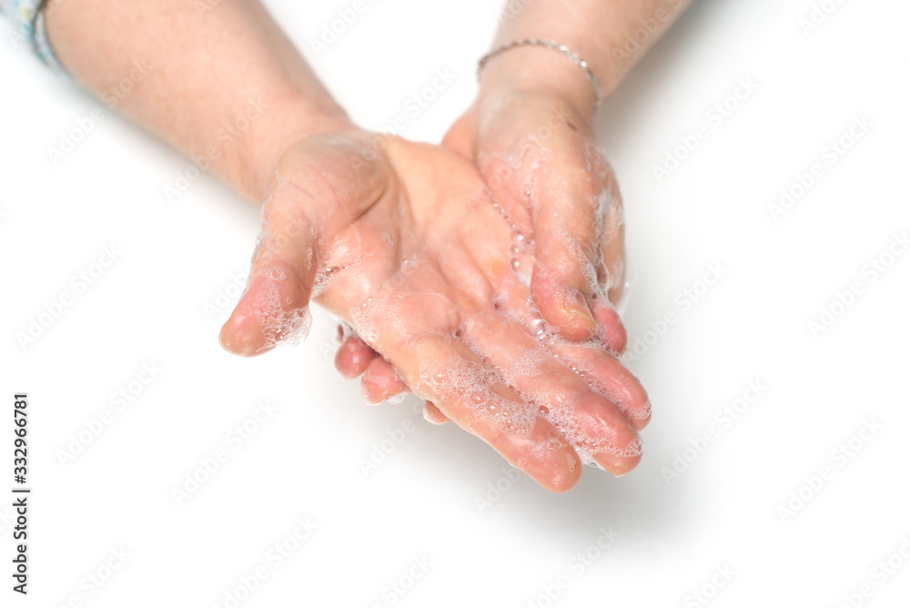 Closeup of hands of woman whashing hands on white background to protect against the coronavirus
