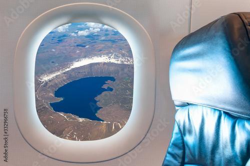 Nemrut Lake with ships as seen through window of an commerical passenger airplane