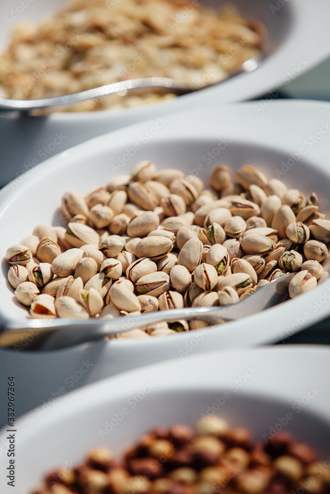 close-up tasty inshell pistachios in a ceramic bowl