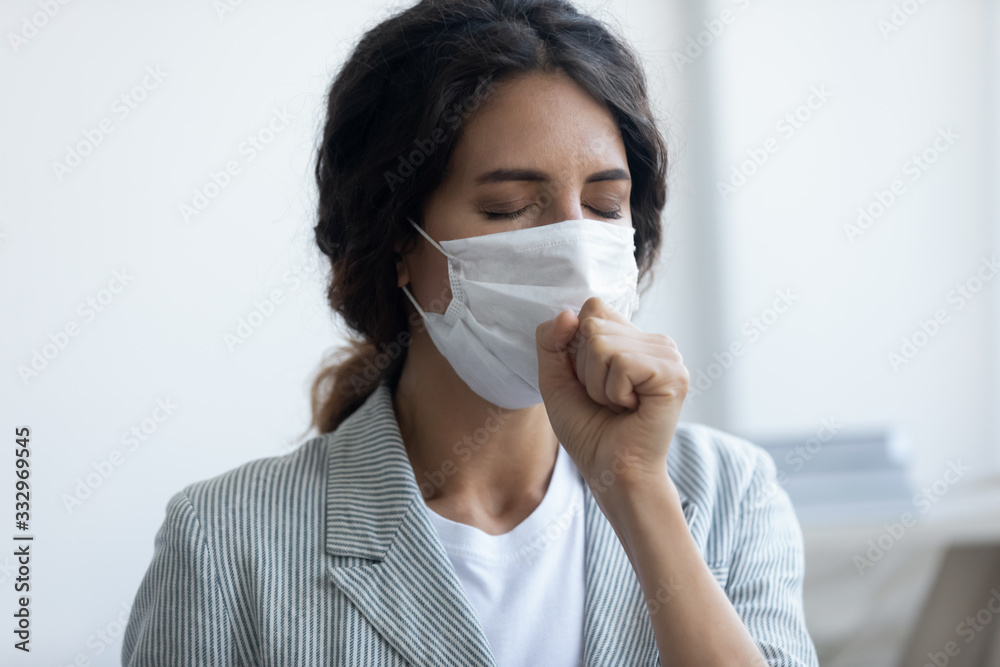 Sick young woman wear face medical mask cough suffer from corona virus pandemic outbreak, unhealthy female in protective facial cover infected with covid-19 coronavirus epidemic, healthcare concept Sick young woman wear face medical mask cough suffer from corona virus pandemic outbreak, unhealthy female in protective facial cover infected with covid-19 coronavirus epidemic, healthcare concept