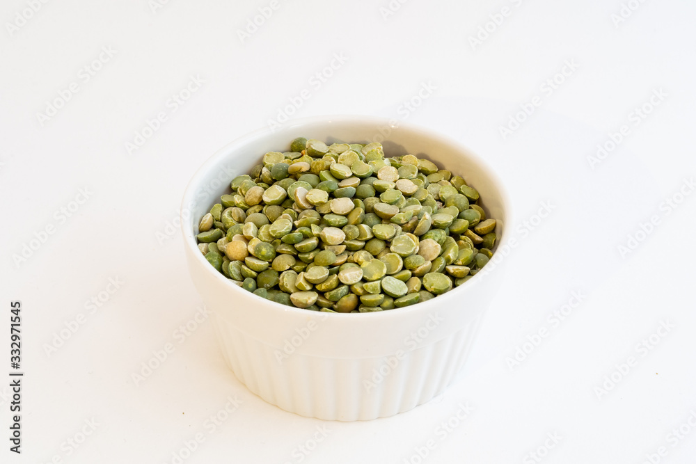 Split peas in a small white bowl isolated on a white background Split peas in a small white bowl isolated on a white background