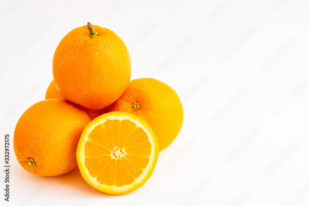 Four oranges stacked and an orange slice isolated on a white background Four oranges stacked and an orange slice isolated on a white background