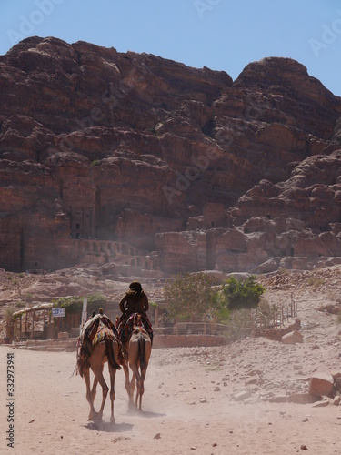 two camels in front of the famous Royal Tombs of Petra, UNESCO world heritage, Wadi Musa, Jordan, Middle East
