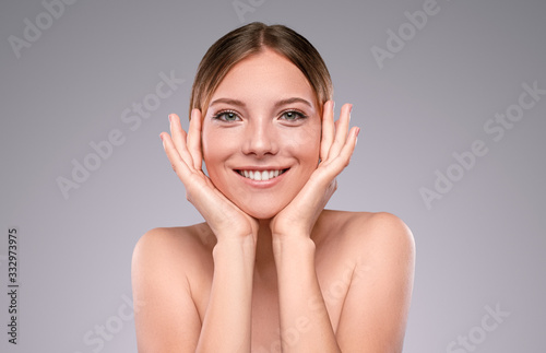 Happy young woman with clean skin looking at camera