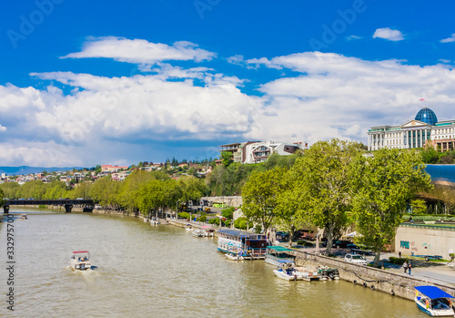 View Of Kura Mtkvari River Under Baratashvili Bridge, Embankment And City Neighborhood from Bridge Of Peace.Tbilisi, Georgia