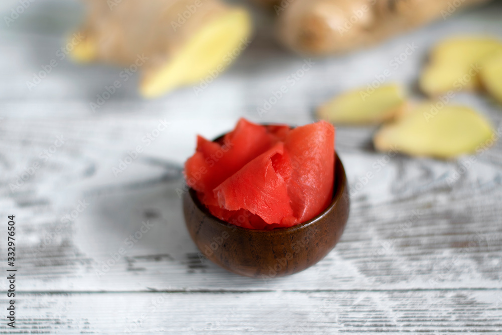 Pickled and fresh ginger root on the white wooden table Pickled and fresh ginger root on the white wooden table