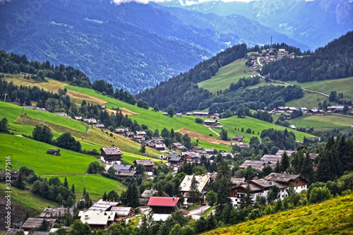 La Clusaz, France - August 9th 2017 : Mountain landscape taken near the hamlet la Clusaz, in the mountain pass of the Aravis, at 10 km of Albertville city. Focus on a small hamlet.