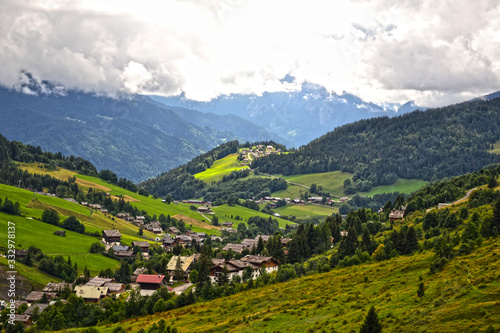 La Clusaz, France - August 9th 2017 : Mountain landscape taken near the hamlet la Clusaz, in the mountain pass of the Aravis, at 10 km of Albertville city. Focus on a small hamlet. photo