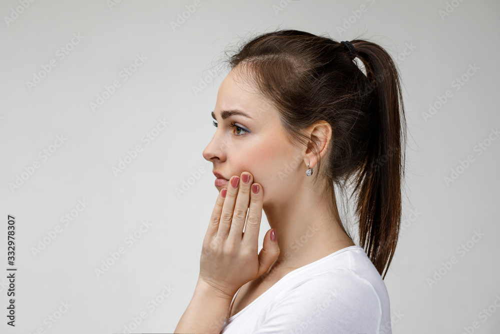 young sad woman suffering from tooth pain, caries. girl having toothache. Dental health and care concept young sad woman suffering from tooth pain, caries. girl having toothache. Dental health and care concept