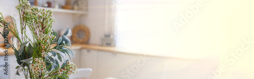 Bouquet of flowers stands in a bright kitchen