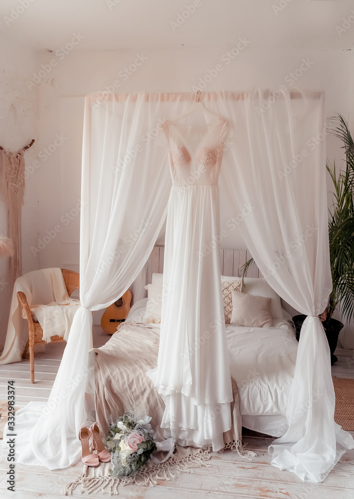 beautiful bride shoes and a bouquet lie on tulle, next to the bride’s dress beautiful bride shoes and a bouquet lie on tulle, next to the bride’s dress