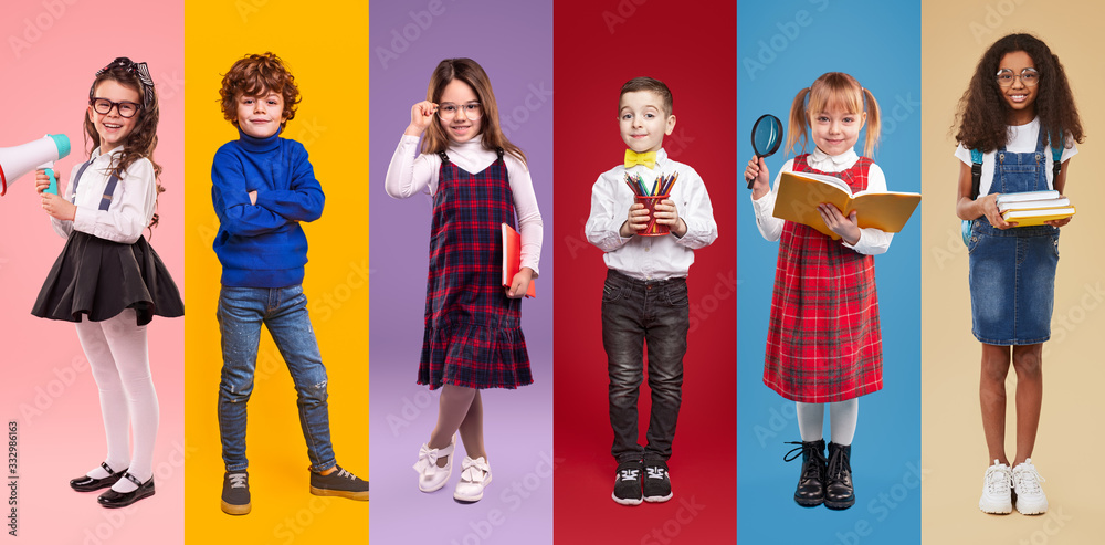 Obraz premium Multiethnic little schoolgirls and schoolboys against colorful background