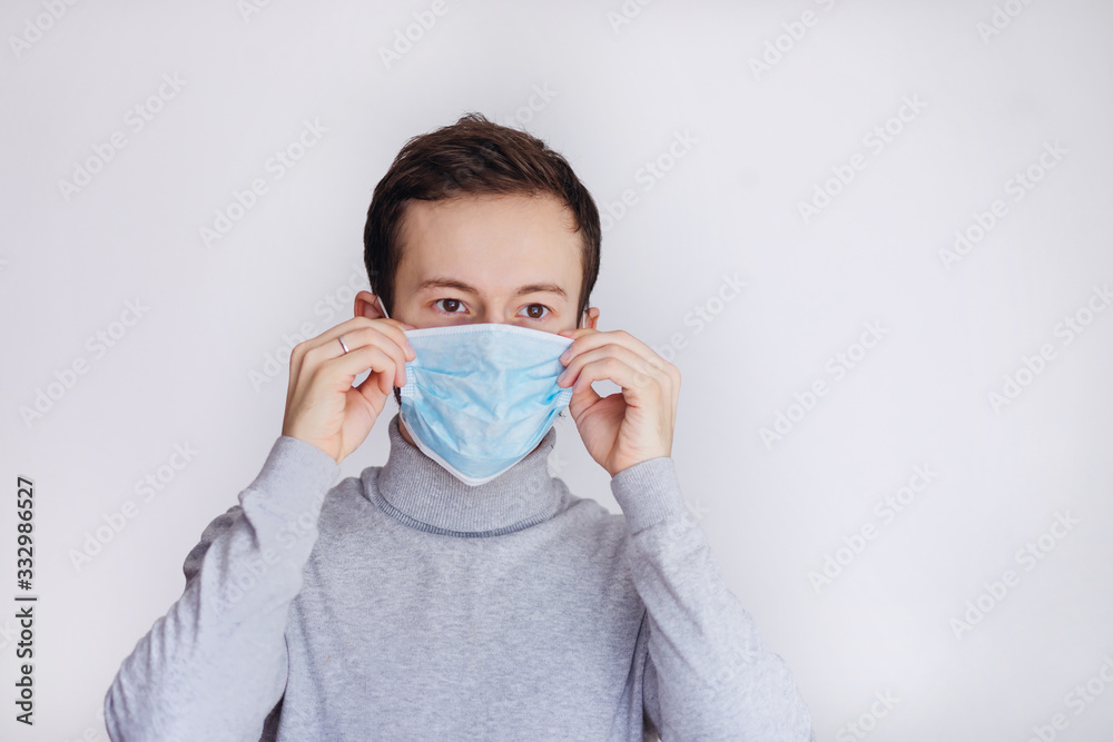 Coronavirus pandemic outbreak prevention portrait. Bearded man wearing protective mask feeling sick with fever with the Covid-19 virus disease symptoms. Coronavirus pandemic outbreak prevention portrait. Bearded man wearing protective mask feeling sick with fever with the Covid-19 virus disease symptoms.