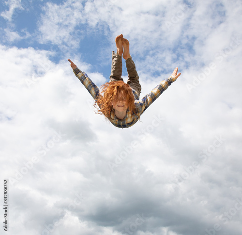 Young boy flying in the air photo