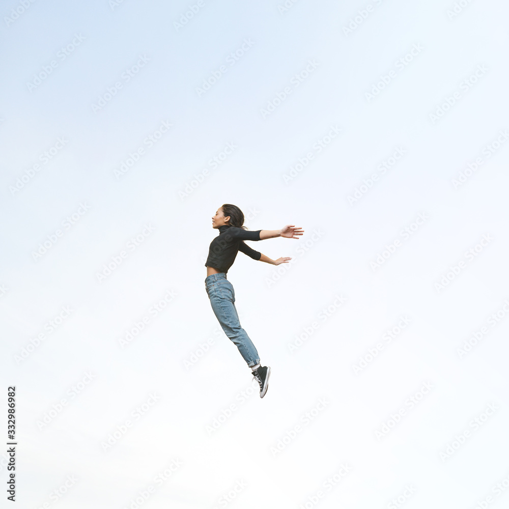 Jumping woman floating in mid air Jumping woman floating in mid air