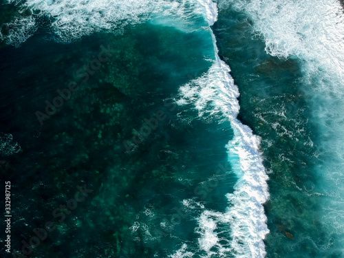 Obraz na plátně Aerial drone view of spashing waves in blue ocean