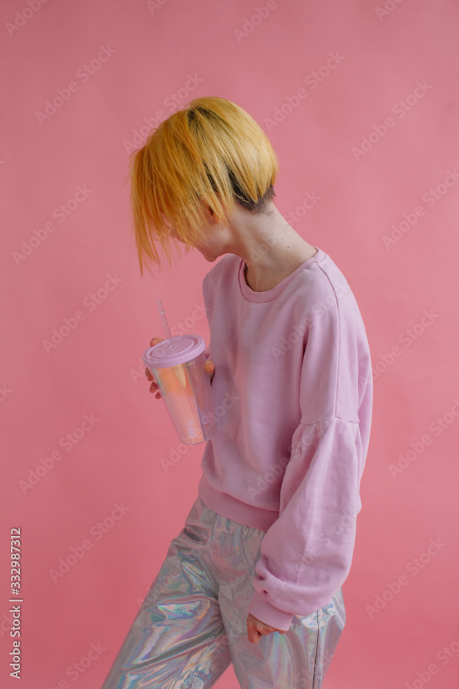 Unrecognizable girl with yellow hair posing in pink studio Unrecognizable girl with yellow hair posing in pink studio