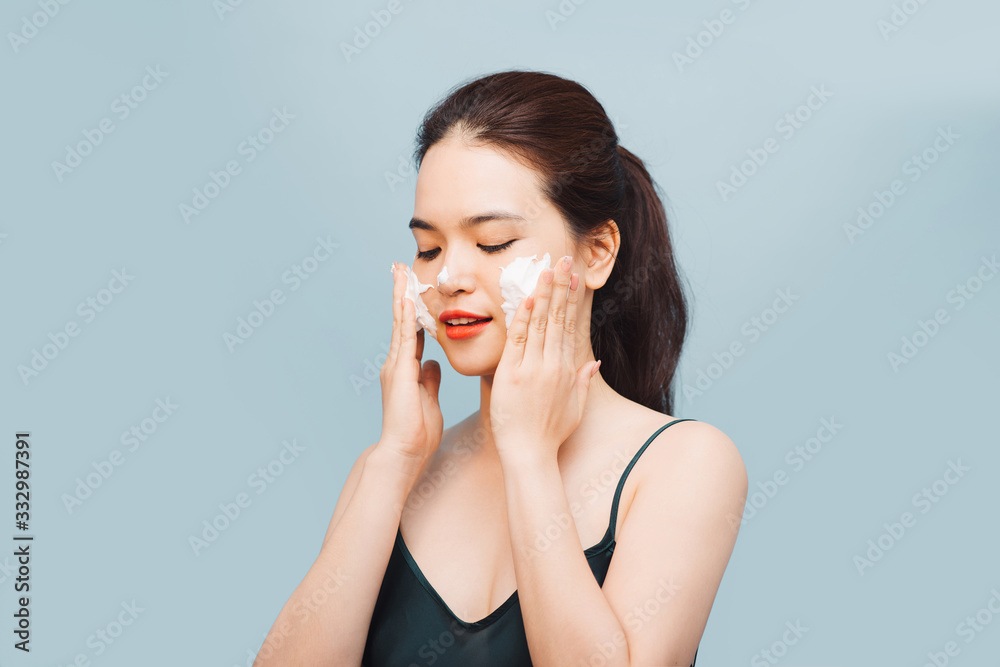 Happy asian woman wash her face with a soap foam Happy asian woman wash her face with a soap foam