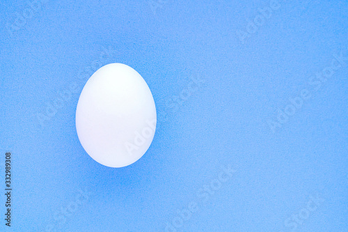 Egg isolated on a blue background close-up.