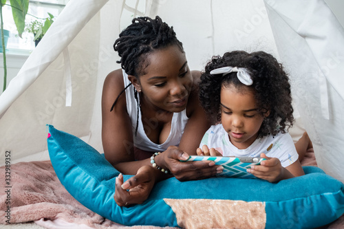 Mother and daughter in a tent photo