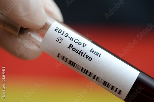 Stock photo of holding tube with Blood Test(novel Coronavirus 2019 disease,COVID-19,nCoV) and flag of Germany. Germany virus outbreak.