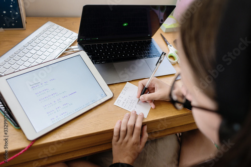 teen doing homework at her desk