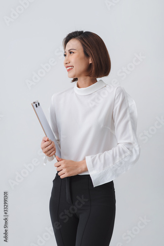 Modern asian business woman holding folder and standing.