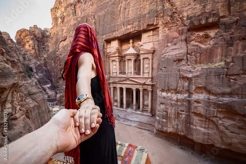 Girl holding hand looking at Treasury, Petra in Jordan