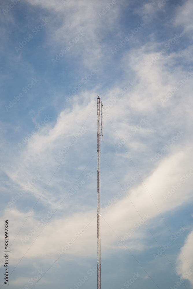 Obraz premium Telecommunication tower with blue sky and cloud