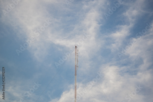 Telecommunication tower with blue sky and cloud