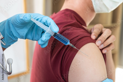 Doctor making injection vaccination patient to prevent pandemic of the disease