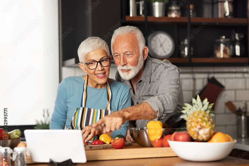 Cute senior couple preparing some healthy meal in the kitchen Cute senior couple preparing some healthy meal in the kitchen