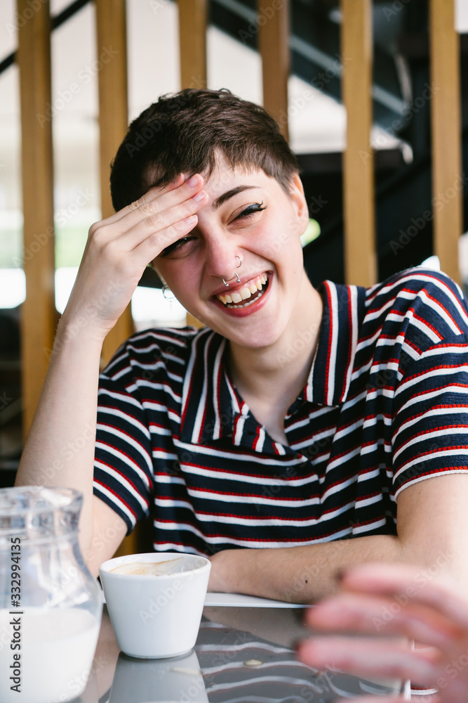 Girl With Piercings Laughing And Having A Cup Of Coffee With Milk. Girl With Piercings Laughing And Having A Cup Of Coffee With Milk.