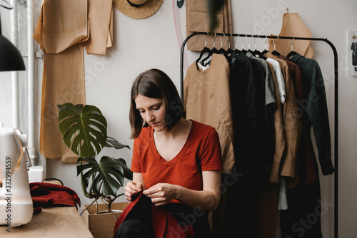 Woman sew by hand with needle and thread. photo