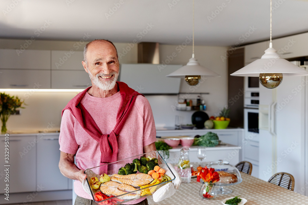 Senior man with the healthy food tray in the kitchen Senior man with the healthy food tray in the kitchen