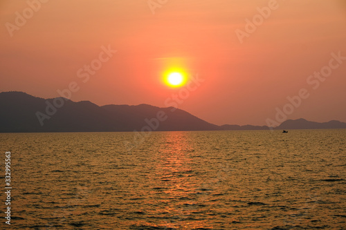 golden sun light sunset in sea behind island. silhouette mountain on beach romantic place in thailand