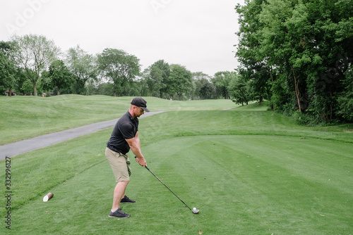 Male Golfer Ready To Hit Ball photo