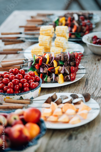 Kabobs and fruits on table photo