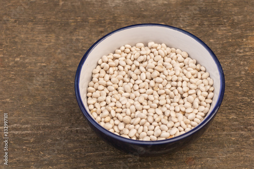 A plate of raw beans on wooden background, Beans benefits