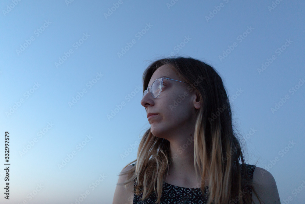 Portrait of a young woman at dusk