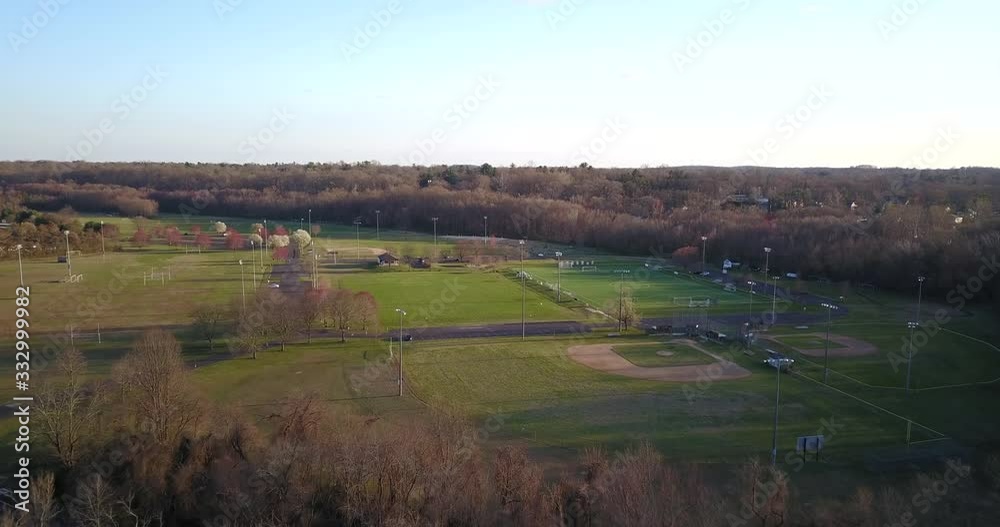 Drone towards small park with baseball diamond and soccer field Drone towards small park with baseball diamond and soccer field