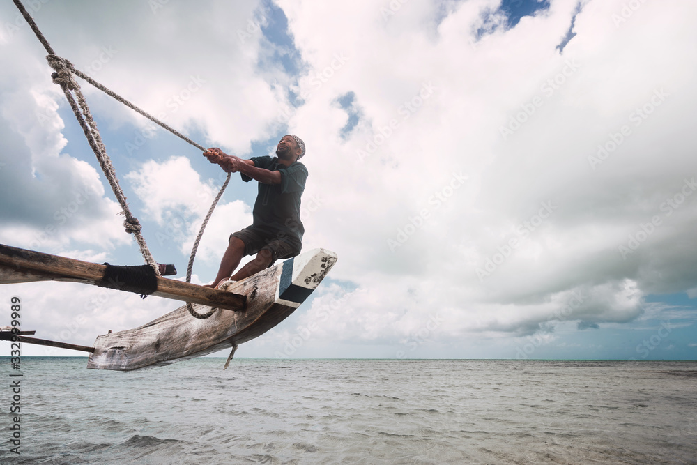 fisherman pulling the rope, keeping the balance to navigate his Stock ...