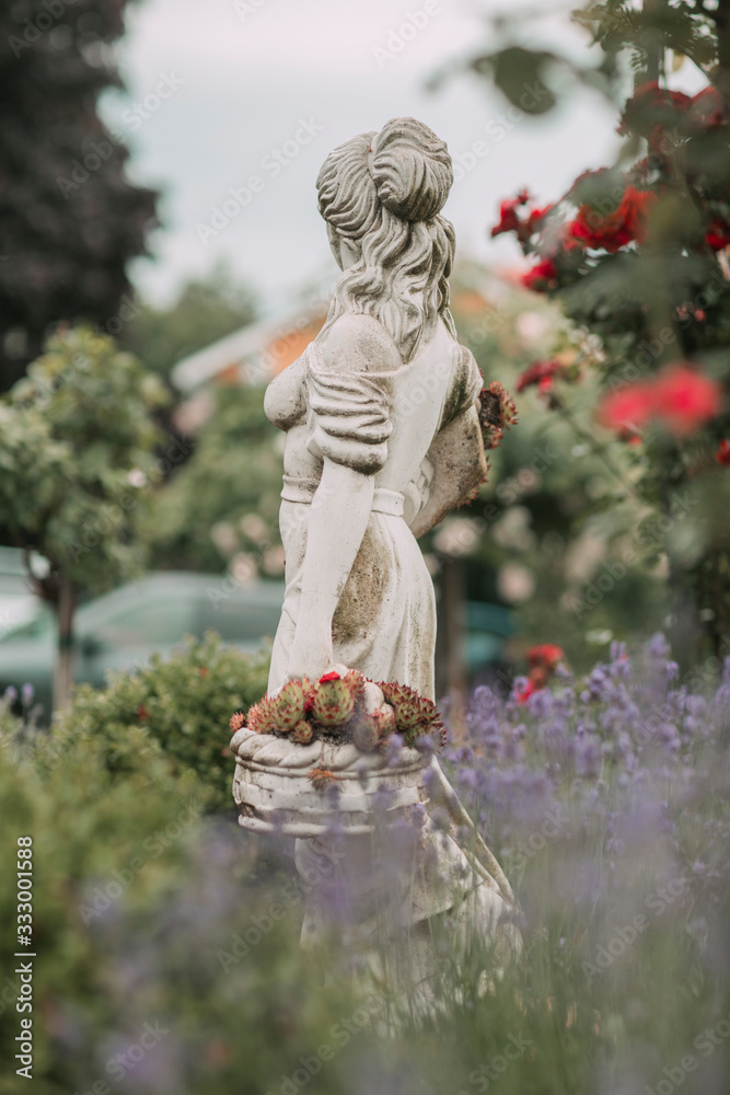 Statue of woman in the garden Stock Photo | Adobe Stock