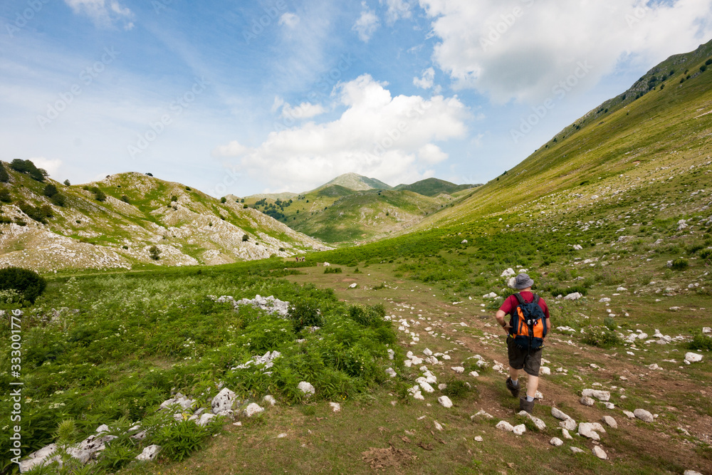 Matese Park, Campania, Italy - july 10 2016: a hiker follows the path that leads from Lake Matese to Mount Miletto