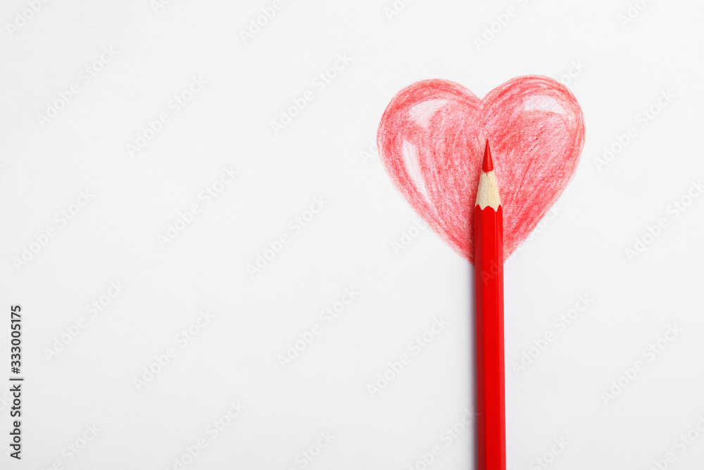 Drawing of heart and red pencil on white background, top view Drawing of heart and red pencil on white background, top view